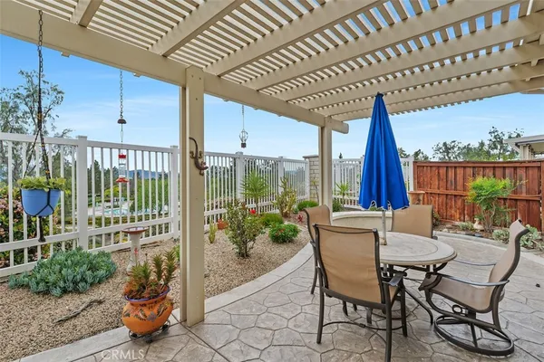 a view of a patio with table and chairs and potted plants