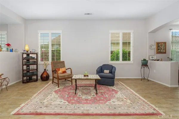 a living room with furniture rug and window
