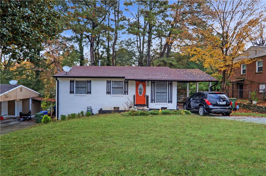a view of a house with a yard and sitting area