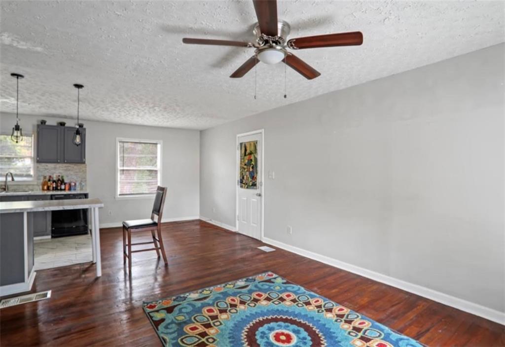 437 Fairlock Lane Northwest Atlanta, GA 30331 - Photo 13 of 26 a living room with wooden floor and ceiling fan