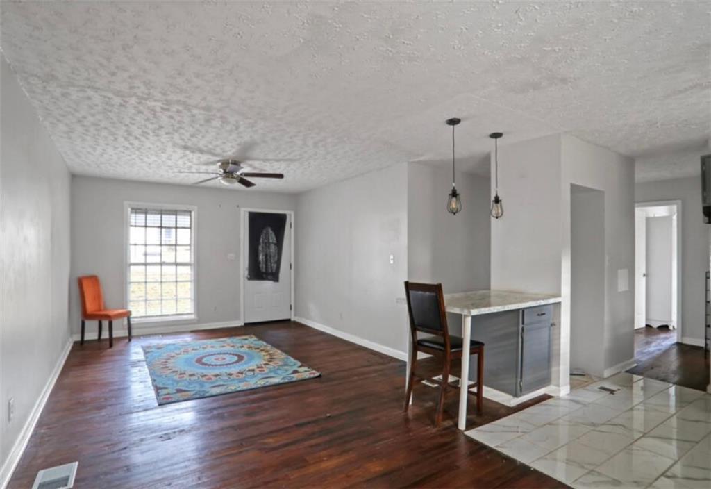 437 Fairlock Lane Northwest Atlanta, GA 30331 - Photo 16 of 26 a view of an empty room with wooden floor and a window
