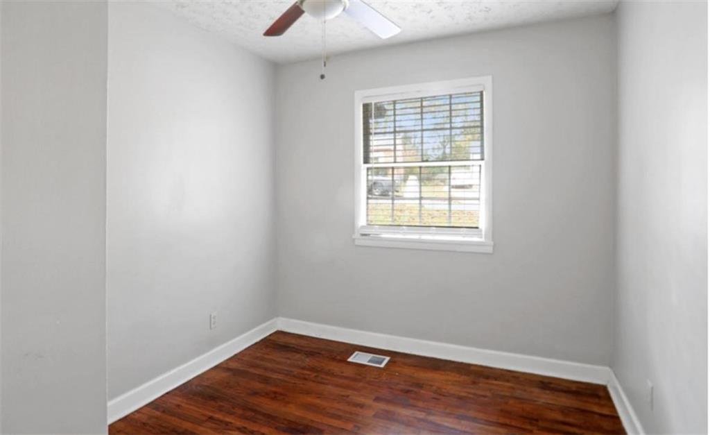 437 Fairlock Lane Northwest Atlanta, GA 30331 - Photo 18 of 26 an empty room with wooden floor and windows