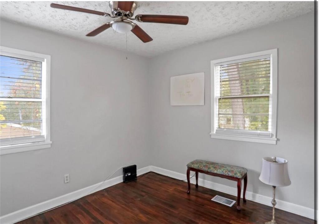 437 Fairlock Lane Northwest Atlanta, GA 30331 - Photo 20 of 26 a view of an empty room with window and wooden floor