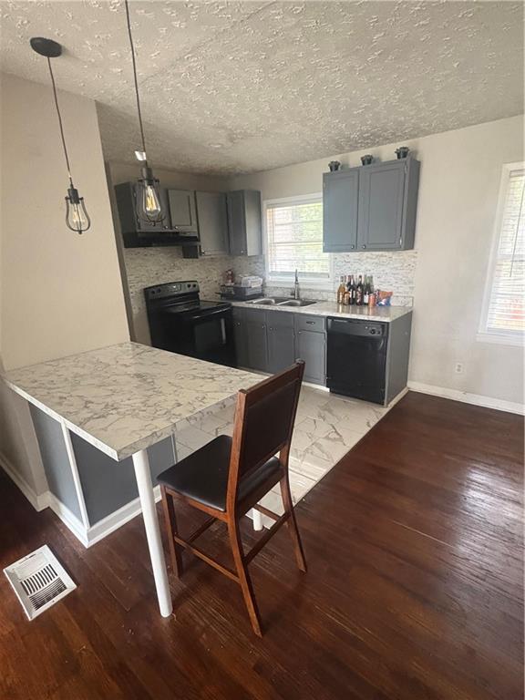 437 Fairlock Lane Northwest Atlanta, GA 30331 - Photo 2 of 26 a kitchen with a kitchen island hardwood floor sink stove dining table and chairs