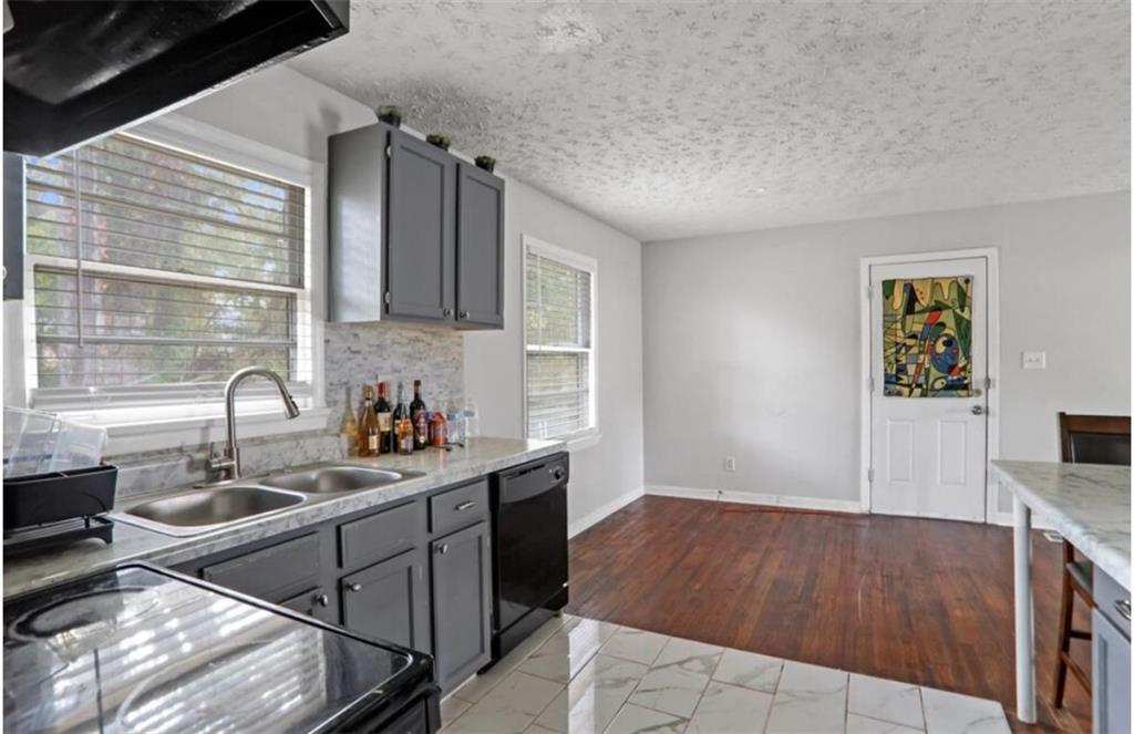 437 Fairlock Lane Northwest Atlanta, GA 30331 - Photo 7 of 26 a kitchen with a sink cabinets and window