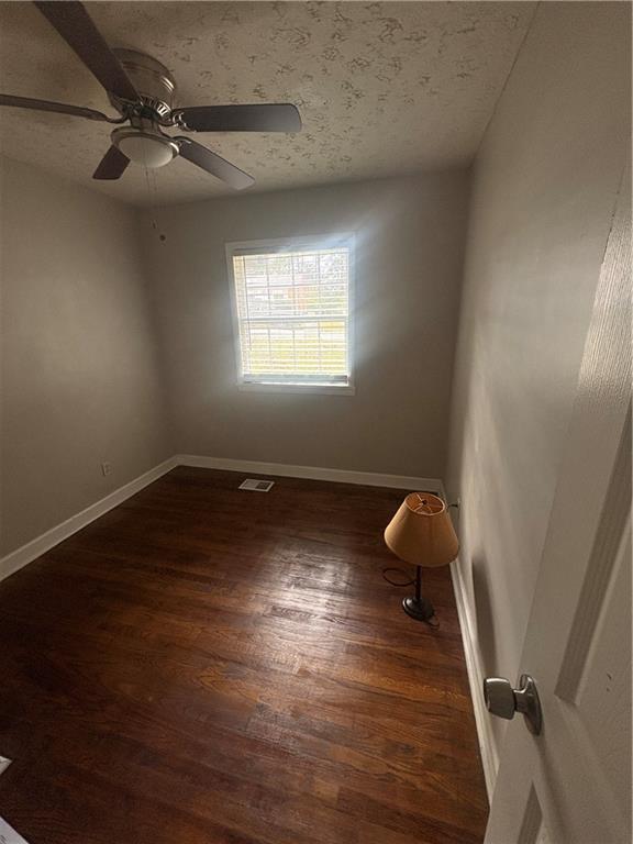 437 Fairlock Lane Northwest Atlanta, GA 30331 - Photo 9 of 26 an empty room with wooden floor and windows