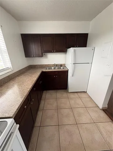 a kitchen with granite countertop a sink and a stove
