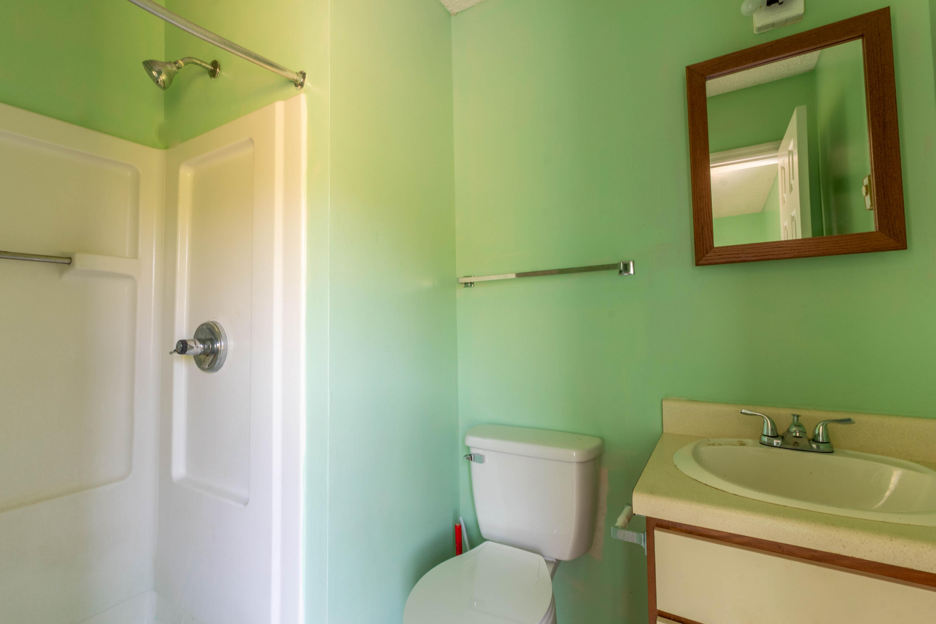4879 Truevine Road Glade Hill, VA 24092 - Photo 8 of 25 a bathroom with a toilet sink and mirror