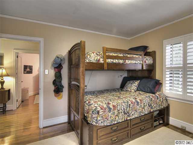 2909 Clover Road Charlotte, NC 28211 - Photo 11 of 16 a bedroom with a large bed and a walk in closet