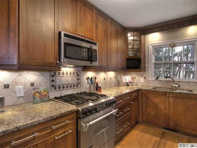 2909 Clover Road Charlotte, NC 28211 - Photo 5 of 16 a kitchen with stainless steel appliances granite countertop a sink stove and microwave