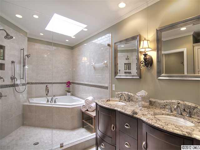 2909 Clover Road Charlotte, NC 28211 - Photo 10 of 16 a bathroom with a bathtub a double vanity sink and mirror