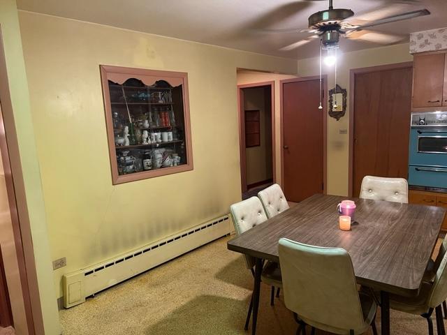 1900 South Roselle Road Roselle, IL 60172 - Photo 5 of 9 a view of a dining room with furniture and wooden floor