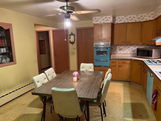 1900 South Roselle Road Roselle, IL 60172 - Photo 6 of 9 a kitchen with stainless steel appliances granite countertop a dining table chairs refrigerator sink and cabinets