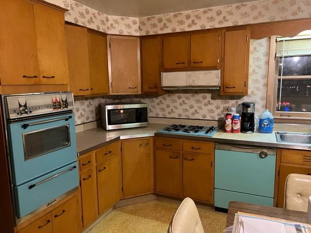 1900 South Roselle Road Roselle, IL 60172 - Photo 7 of 9 a kitchen with a sink cabinets and appliances