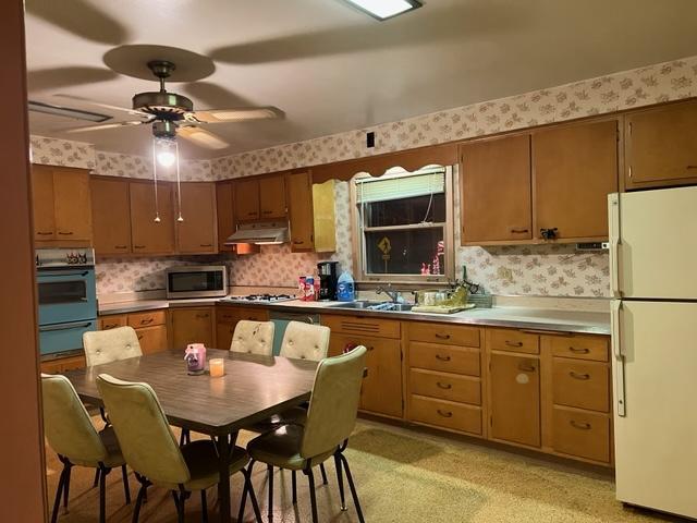 1900 South Roselle Road Roselle, IL 60172 - Photo 9 of 9 a kitchen with stainless steel appliances granite countertop a sink a stove a dining table and chairs