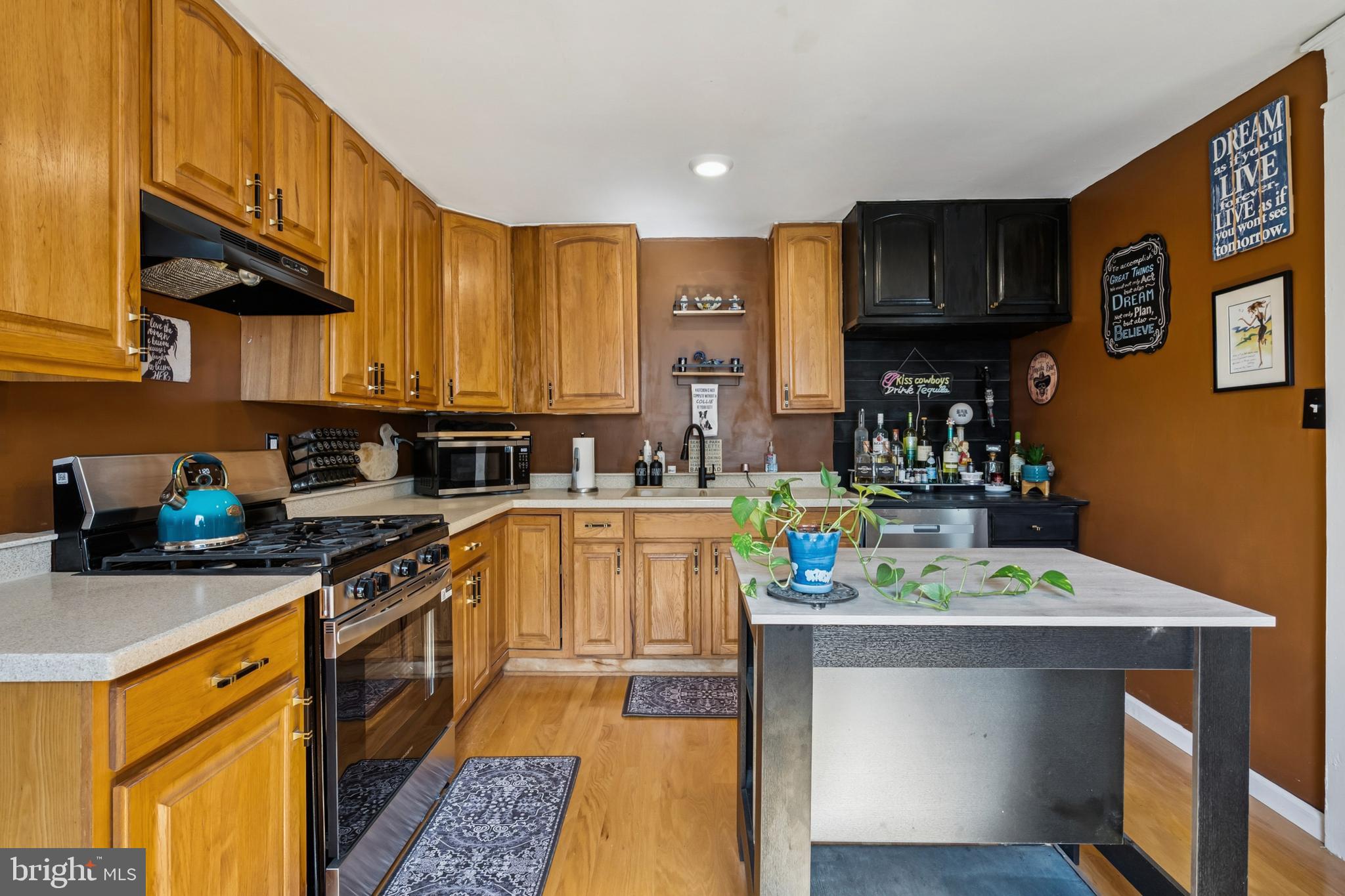 619 Morgan Avenue Palmyra, NJ 08065 - Photo 8 of 27 a kitchen with stainless steel appliances a sink a stove top oven a counter space and cabinets