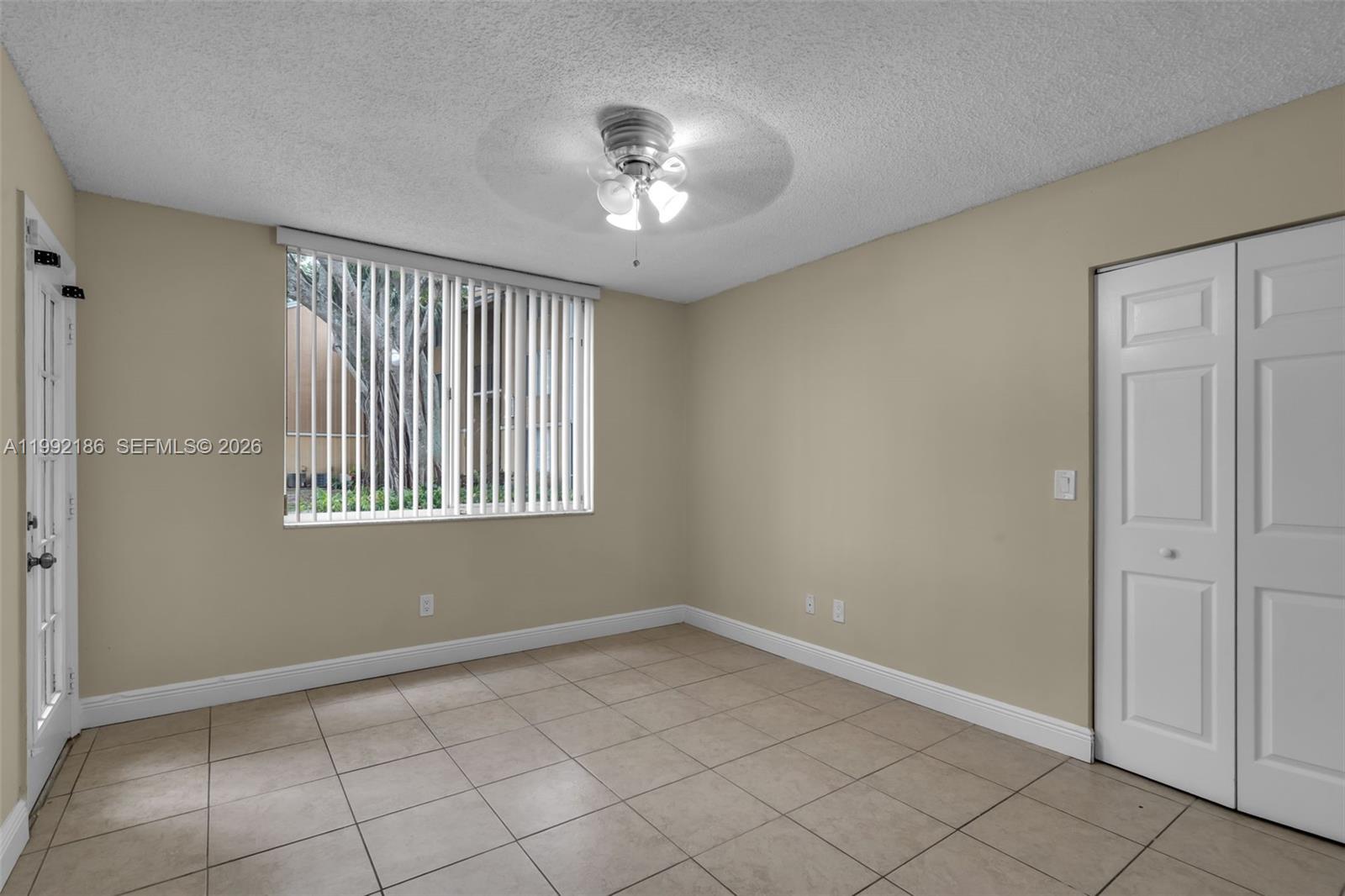 4035 West McNab Road, Unit F101 Pompano Beach, FL 33069 - Photo 11 of 25 a view of an empty room with a window