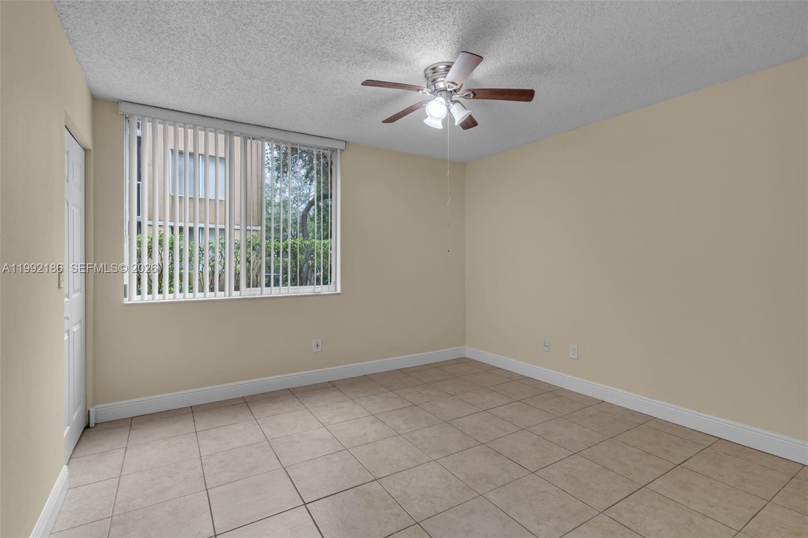 4035 West McNab Road, Unit F101 Pompano Beach, FL 33069 - Photo 18 of 25 wooden floor in an empty room with a window