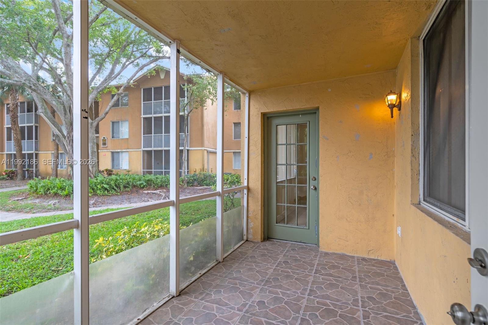 4035 West McNab Road, Unit F101 Pompano Beach, FL 33069 - Photo 20 of 25 a view of front door and porch