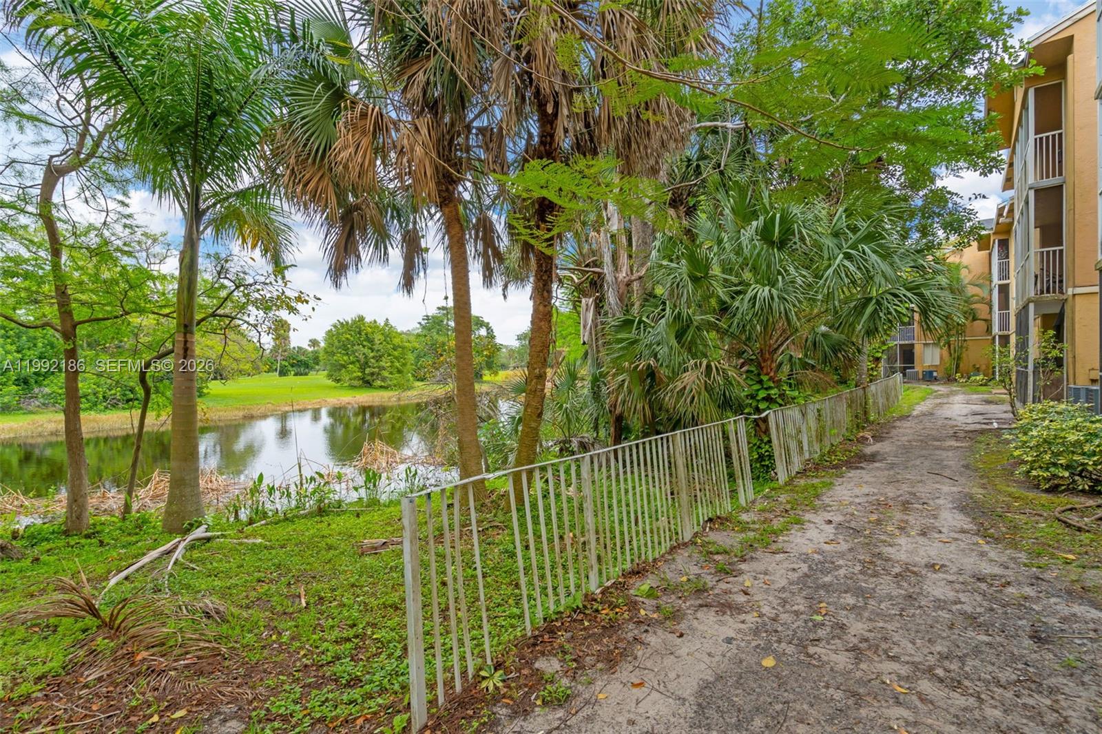 4035 West McNab Road, Unit F101 Pompano Beach, FL 33069 - Photo 22 of 25 a view of a garden and lake