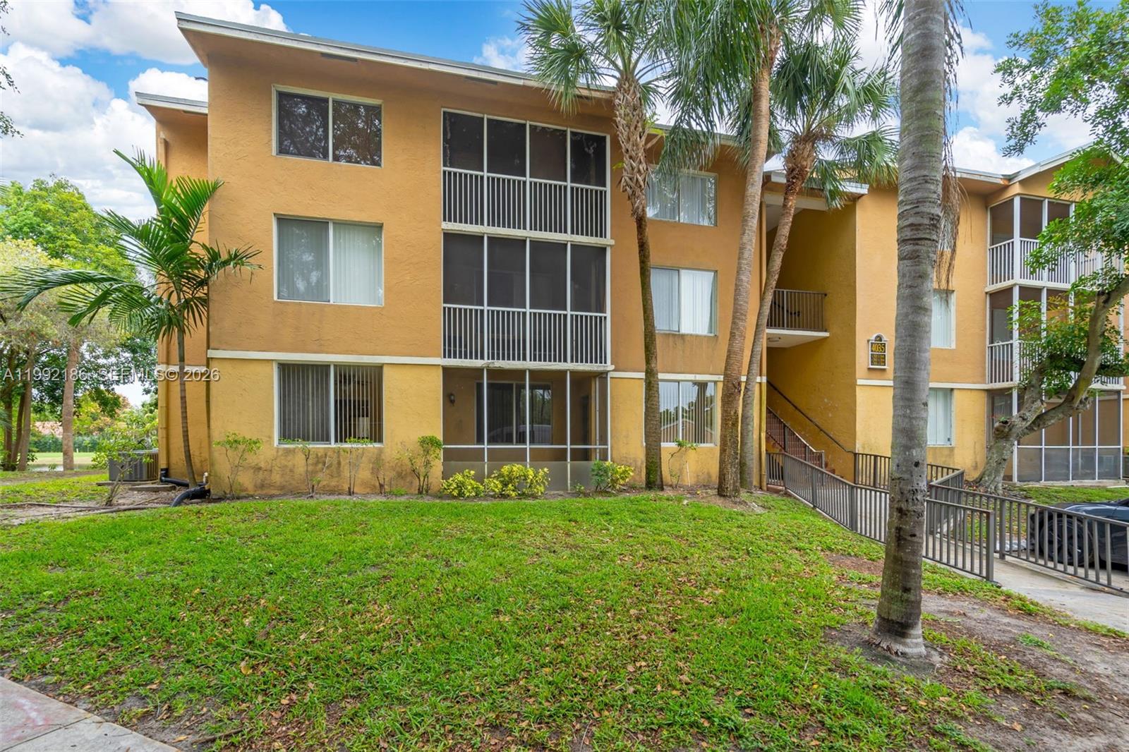 4035 West McNab Road, Unit F101 Pompano Beach, FL 33069 - Photo 23 of 25 a house view with a garden space