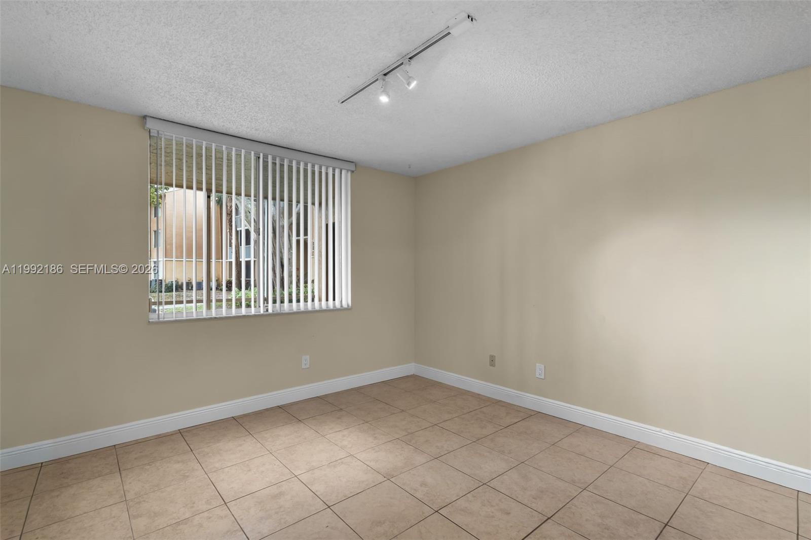 4035 West McNab Road, Unit F101 Pompano Beach, FL 33069 - Photo 10 of 25 an empty room with windows