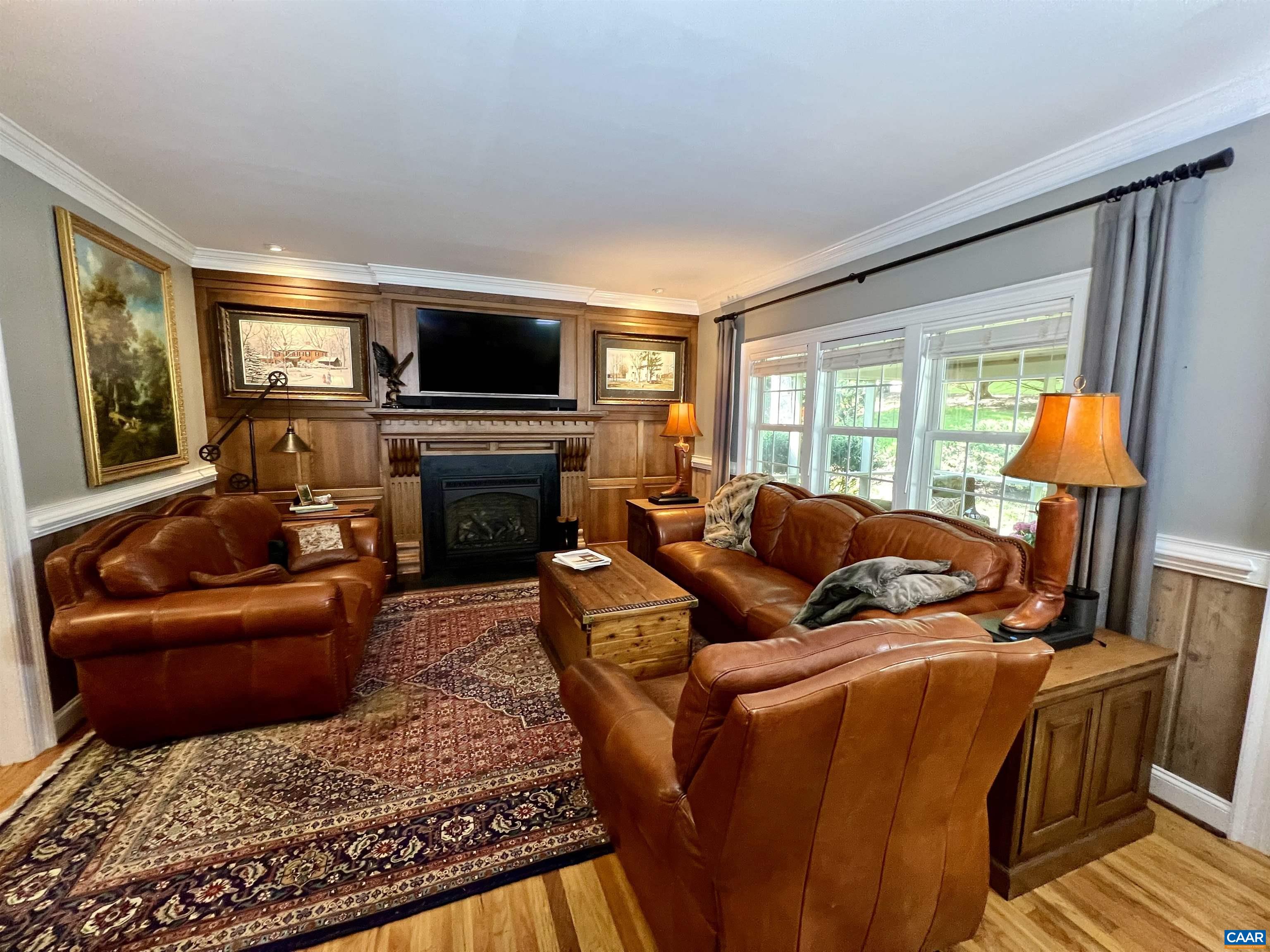 1340 Mosby Rch Charlottesville, VA 22901 - Photo 15 of 62 a living room with furniture a flat screen tv and a fireplace