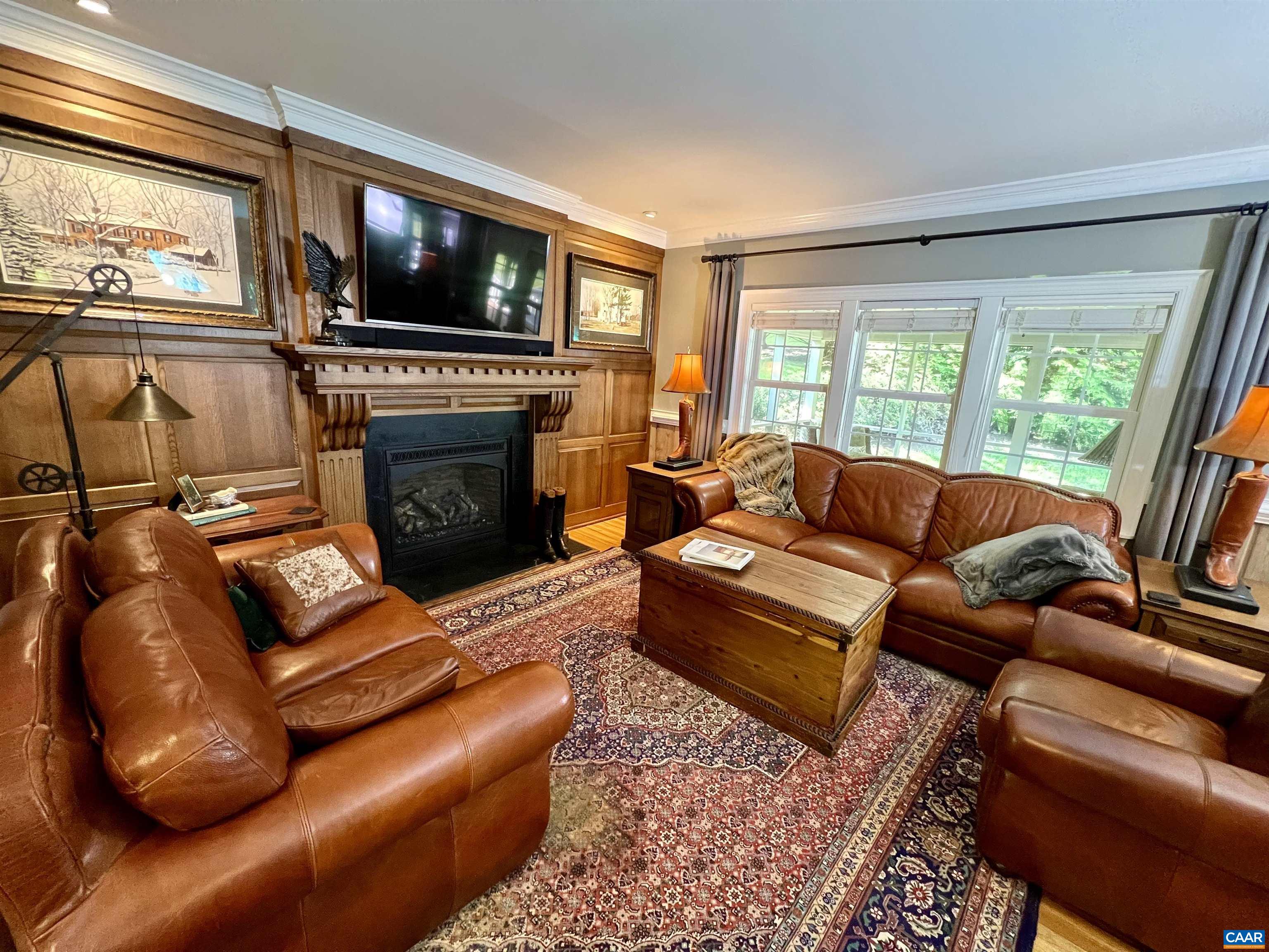 1340 Mosby Rch Charlottesville, VA 22901 - Photo 16 of 62 a living room with furniture a flat screen tv and a fireplace