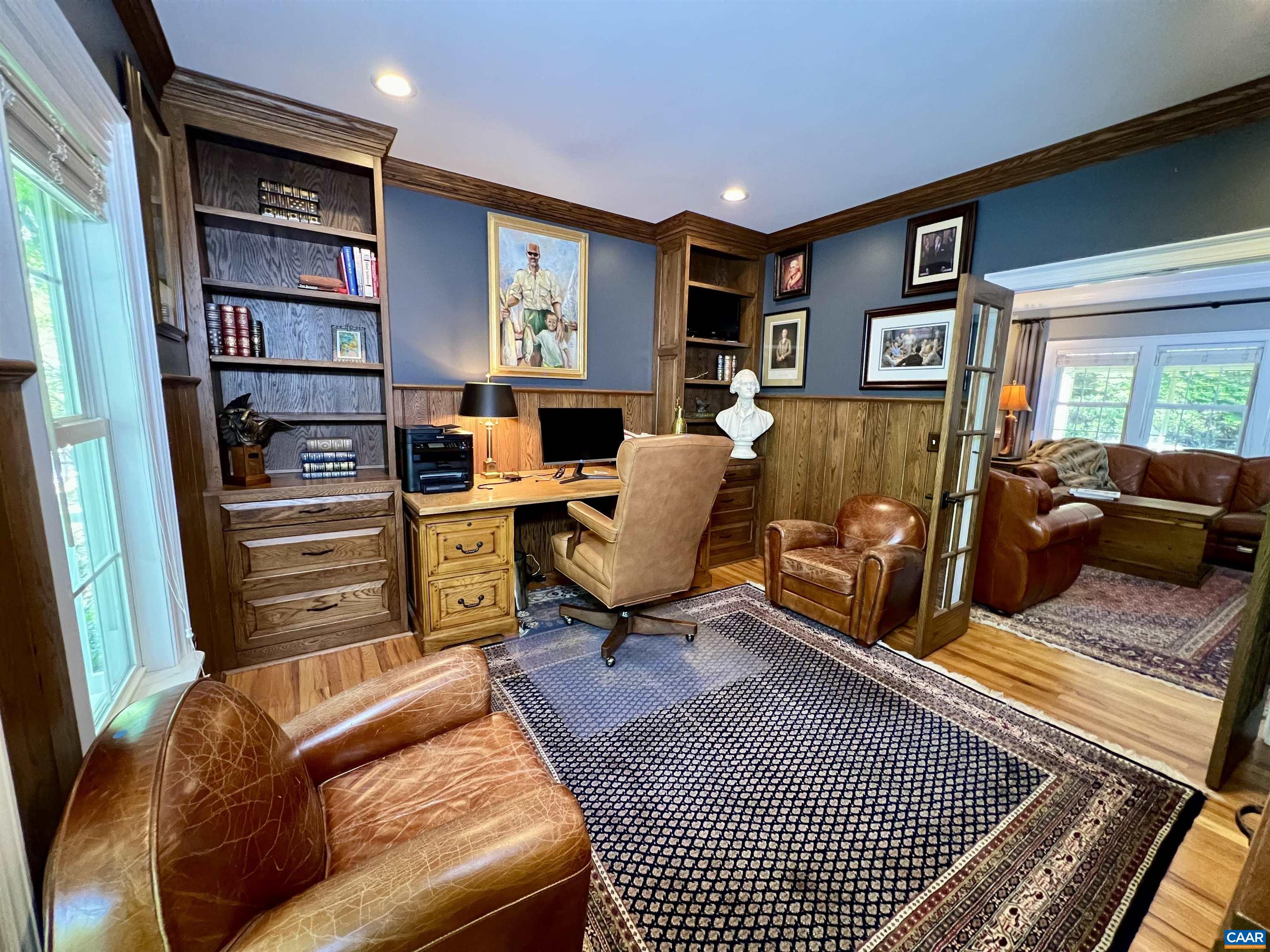 1340 Mosby Rch Charlottesville, VA 22901 - Photo 31 of 62 a living room with furniture a rug and a book shelf