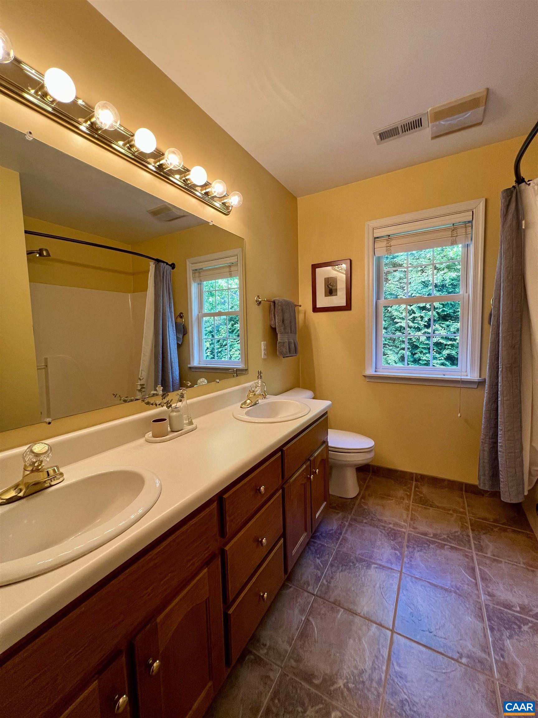1340 Mosby Rch Charlottesville, VA 22901 - Photo 45 of 62 a spacious bathroom with a double vanity sink a mirror and a toilet