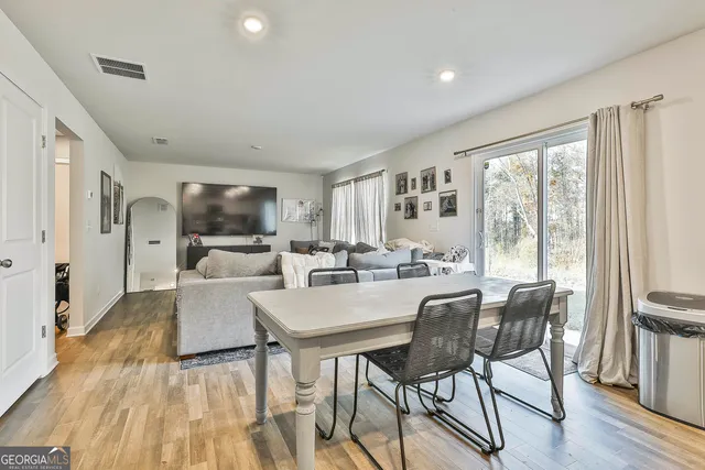a view of a dining room with furniture window and wooden floor