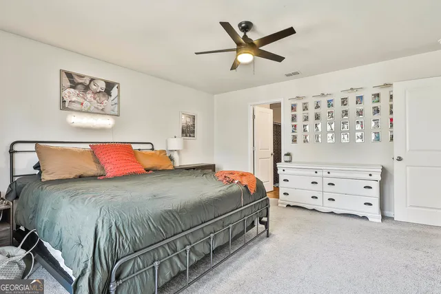 a bathroom with a granite countertop sink mirror and toilet