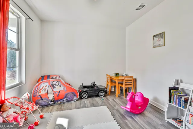 a bedroom with furniture and a book shelf