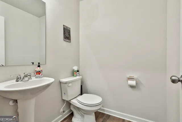 a bathroom with a sink mirror and toilet