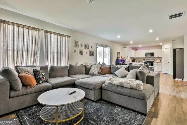 a living room with furniture and a large window