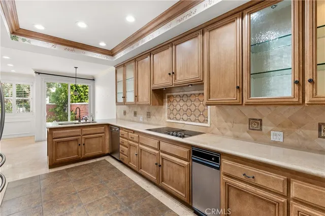 a kitchen with kitchen island granite countertop a sink window and cabinets