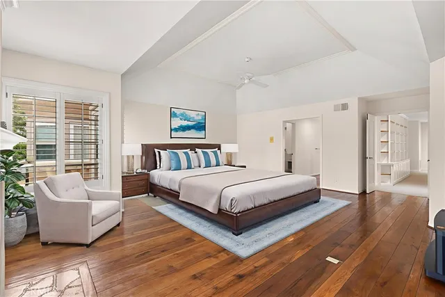 a spacious bedroom with a bed and a couch