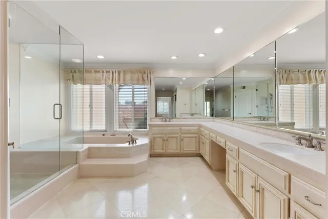 a large spacious bathroom with a large tub shower and sink