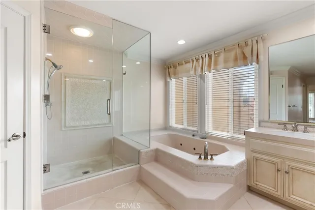 a bathroom with a bathtub a shower a sink and a mirror