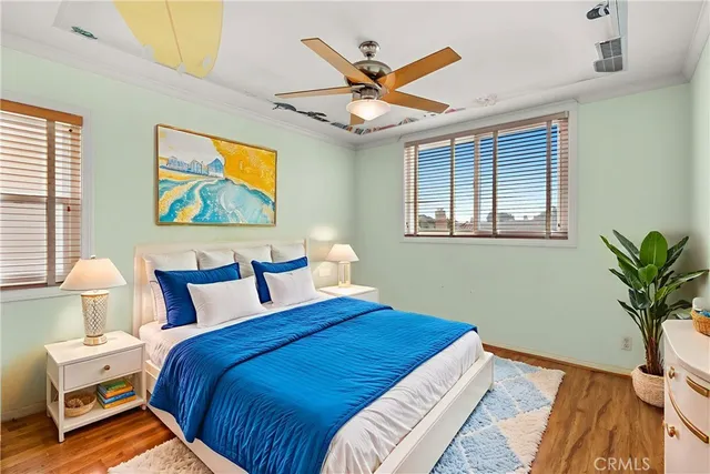 a bedroom with a bed and a painting on the wall