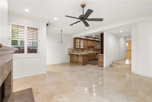 a kitchen with stainless steel appliances kitchen island granite countertop a sink and a stove top oven