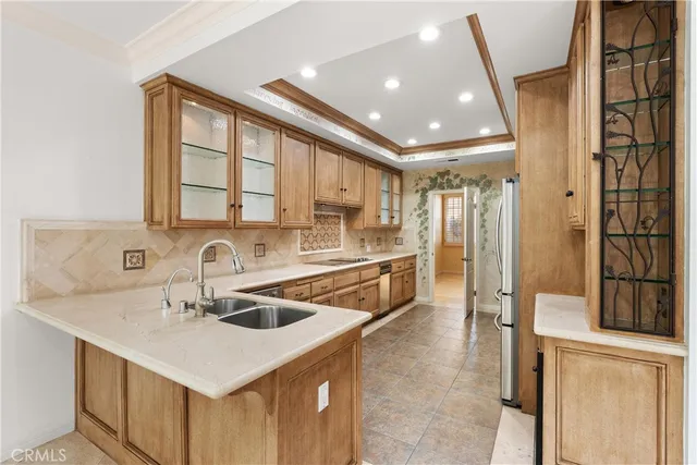 a kitchen with a sink a counter top space and stainless steel appliances
