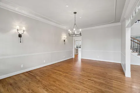 a view of empty room with wooden floor and fireplace