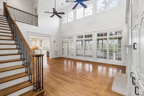 a kitchen with stainless steel appliances granite countertop a lot of counter space and wooden floors