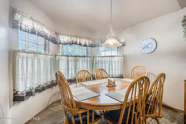 a dining room with furniture a chandelier and a rug