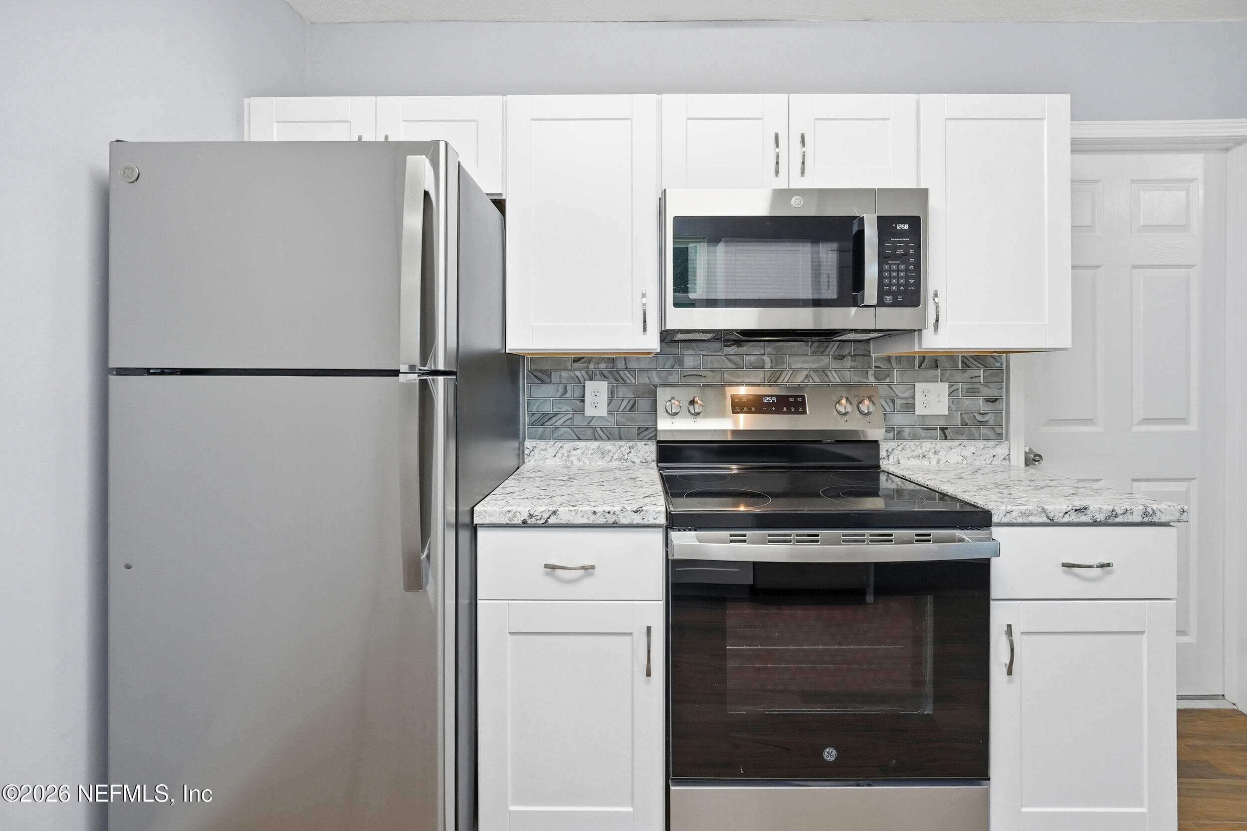 3084 Parental Home Road Jacksonville, FL 32216 - Photo 12 of 31 a kitchen with a stove microwave and refrigerator