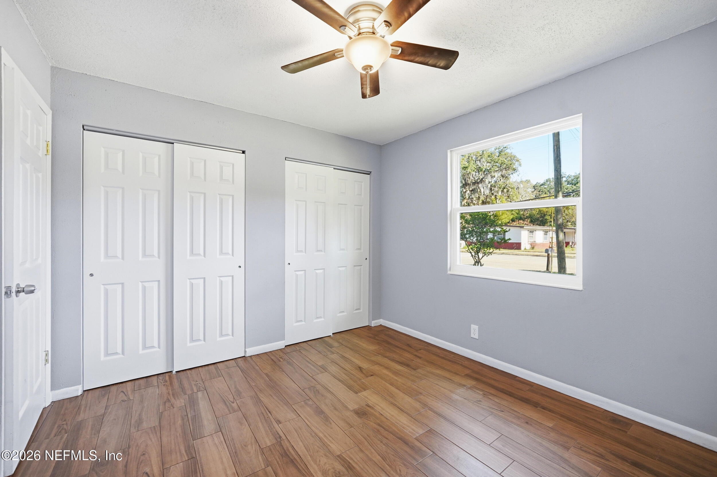 3084 Parental Home Road Jacksonville, FL 32216 - Photo 15 of 31 wooden floor in an empty room with a window