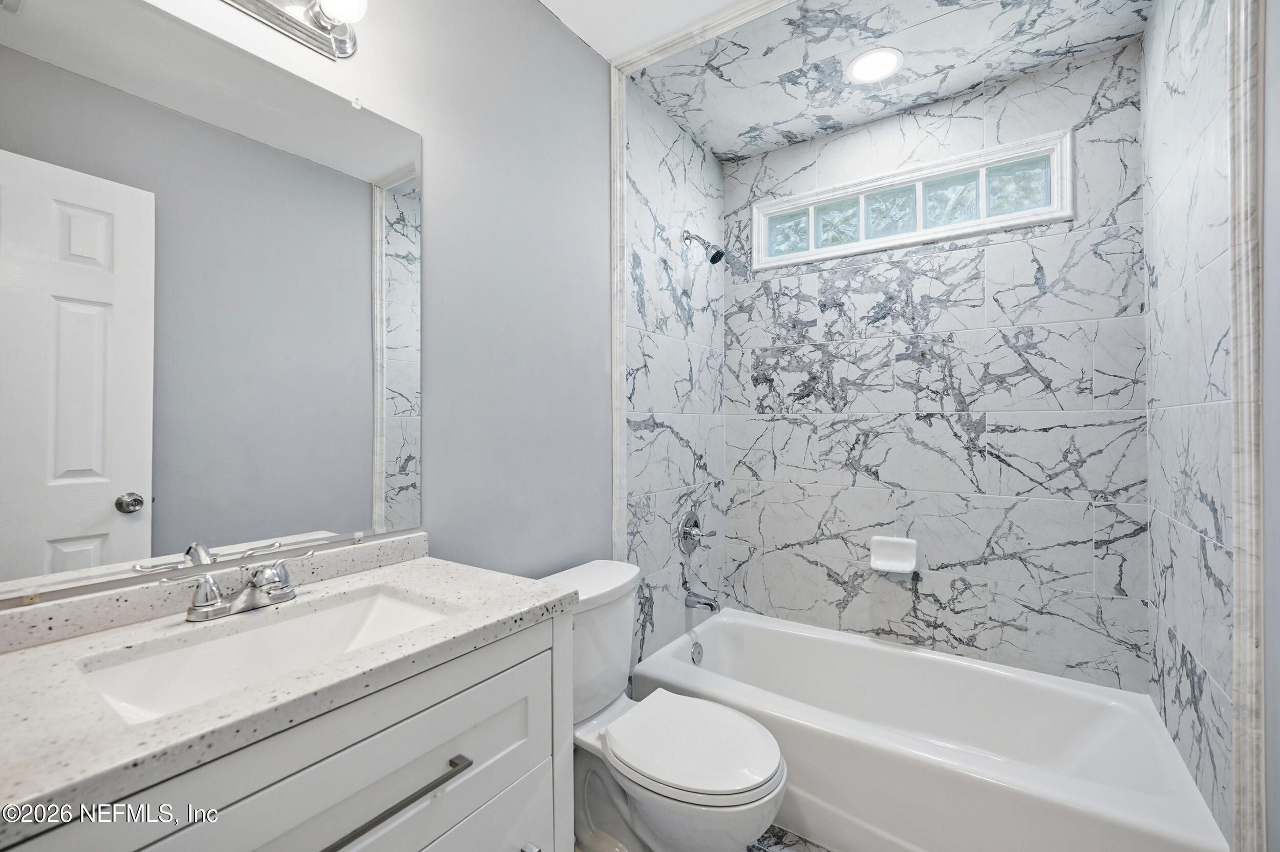 3084 Parental Home Road Jacksonville, FL 32216 - Photo 19 of 31 a bathroom with a granite countertop sink a toilet and bathtub