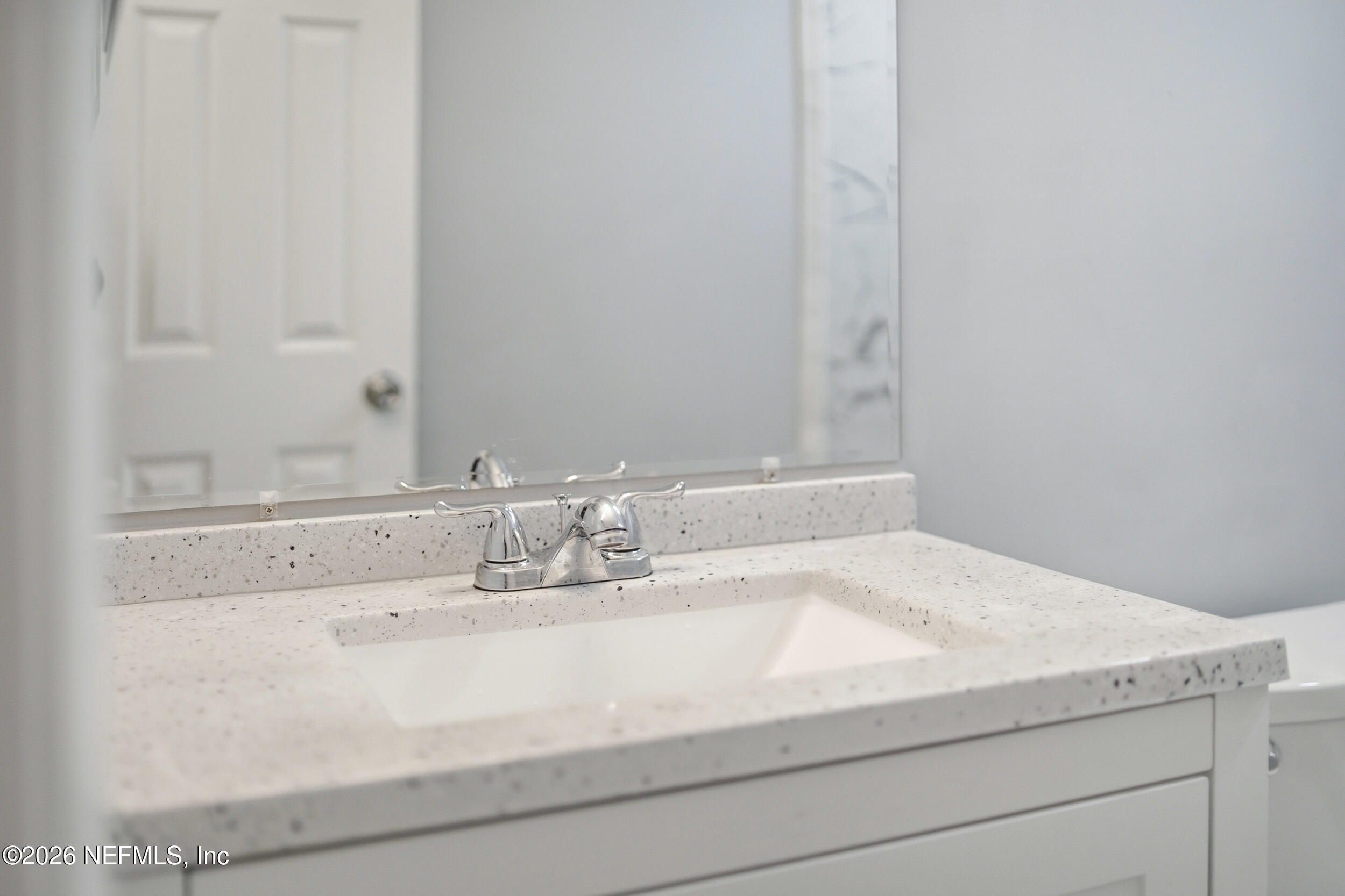 3084 Parental Home Road Jacksonville, FL 32216 - Photo 20 of 31 a bathroom with a sink and a mirror