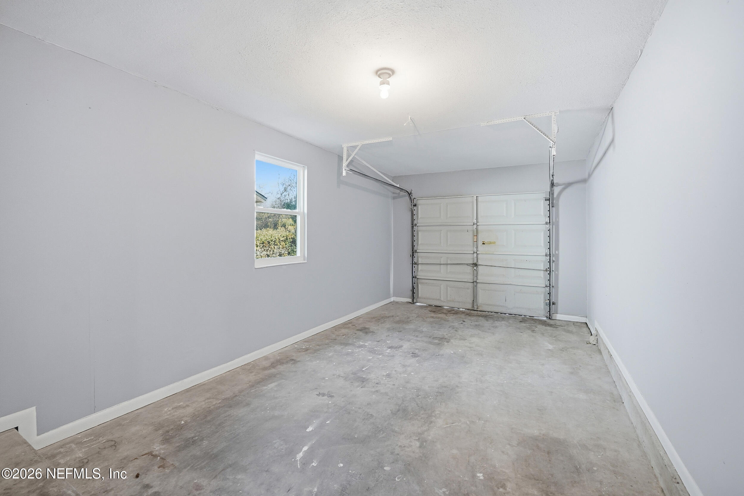 3084 Parental Home Road Jacksonville, FL 32216 - Photo 22 of 31 an empty room with cabinet and windows